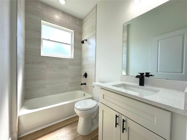 bathroom with shower / tub combination, wood finished floors, toilet, and vanity