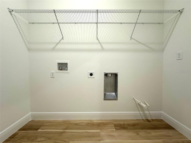 washroom with laundry area, hookup for a washing machine, baseboards, wood finished floors, and hookup for an electric dryer