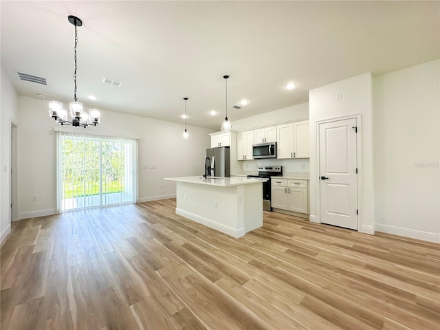 977 W Anderson Ln, Citrus Springs, FL 34434 - kitchen with stainless steel appliances, a chandelier, baseboards, light wood finished floors, and recessed lighting