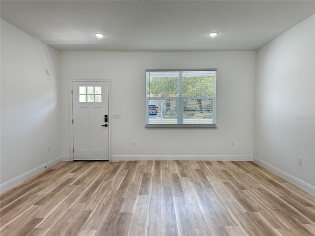 977 W Anderson Ln, Citrus Springs, FL 34434 - entryway featuring light wood-style floors, baseboards, a textured ceiling, and recessed lighting