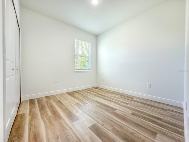 977 W Anderson Ln, Citrus Springs, FL 34434 - unfurnished bedroom featuring light wood finished floors, baseboards, and a closet