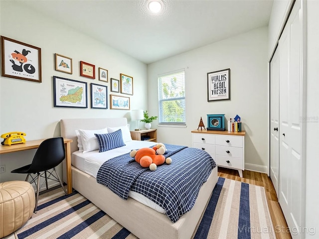 977 W Anderson Ln, Citrus Springs, FL 34434 - bedroom with a closet, wood finished floors, and baseboards