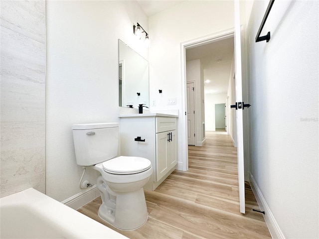 977 W Anderson Ln, Citrus Springs, FL 34434 - full bath with wood finished floors, toilet, vanity, and baseboards