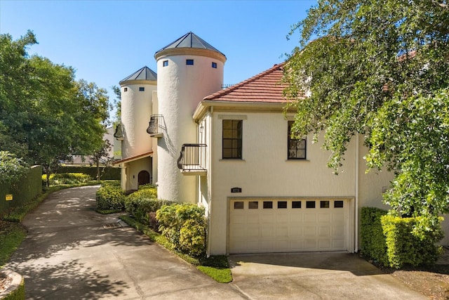 1276 S Pennsylvania Ave Unit 12, Winter Park, FL 32789 - view of front facade with a standing seam roof, metal roof, an attached garage, concrete driveway, and stucco siding