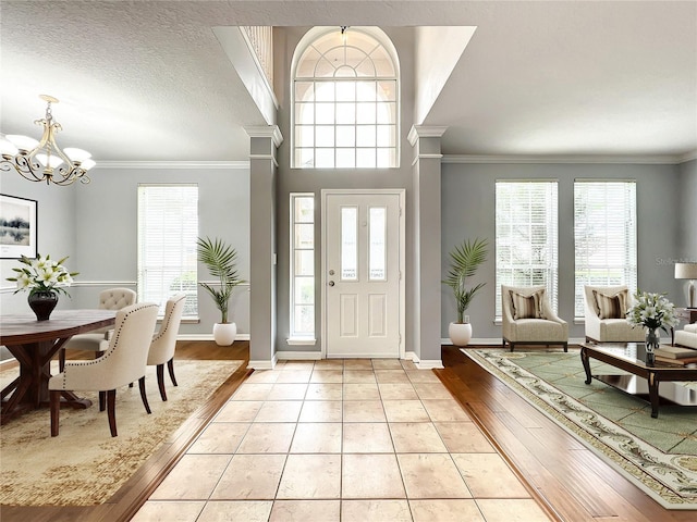 10915 Piping Rock Cir, Orlando, FL 32817 - entryway featuring a chandelier, plenty of natural light, and ornamental molding
