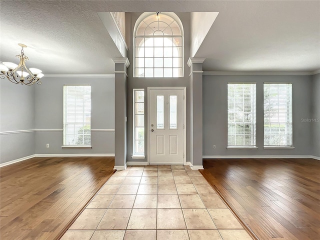 10915 Piping Rock Cir, Orlando, FL 32817 - foyer entrance featuring a chandelier, light wood-style floors, and a healthy amount of sunlight