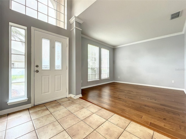 10915 Piping Rock Cir, Orlando, FL 32817 - entrance foyer featuring wood-type flooring, baseboards, ornamental molding, and visible vents