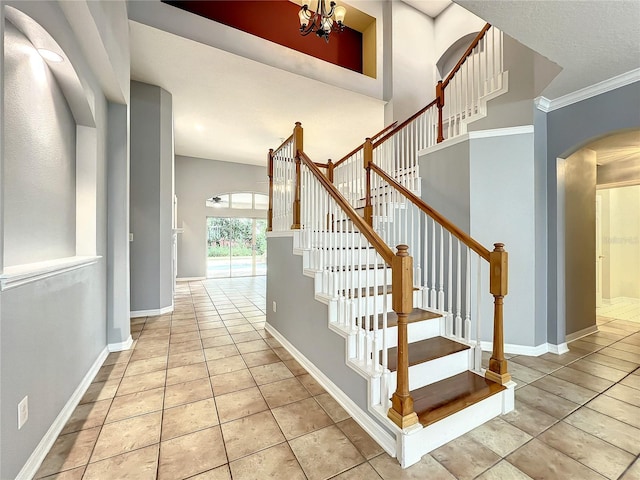 10915 Piping Rock Cir, Orlando, FL 32817 - stairs with baseboards, arched walkways, an inviting chandelier, crown molding, and tile patterned floors