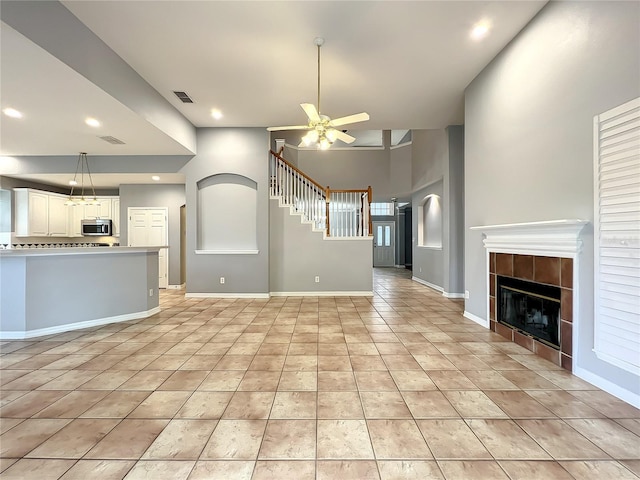 10915 Piping Rock Cir, Orlando, FL 32817 - unfurnished living room featuring recessed lighting, a tiled fireplace, light tile patterned floors, visible vents, and ceiling fan