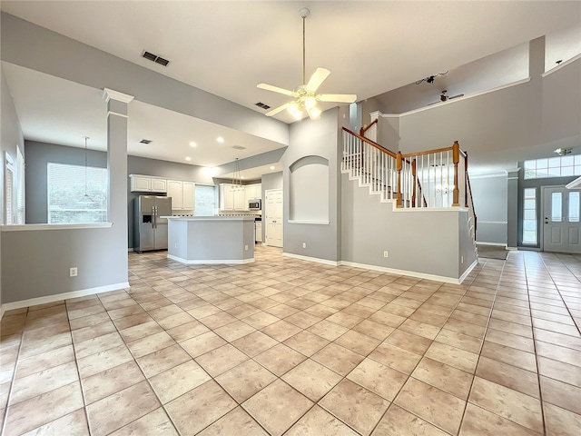 10915 Piping Rock Cir, Orlando, FL 32817 - unfurnished living room featuring light tile patterned floors, baseboards, and a ceiling fan