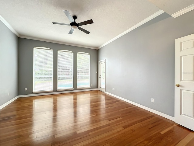 10915 Piping Rock Cir, Orlando, FL 32817 - spare room featuring baseboards, ornamental molding, a textured ceiling, a ceiling fan, and wood finished floors