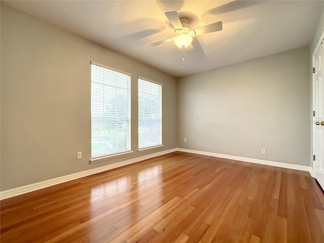 10915 Piping Rock Cir, Orlando, FL 32817 - unfurnished room featuring a textured ceiling, wood finished floors, ceiling fan, and baseboards