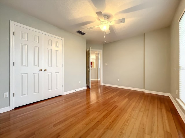 10915 Piping Rock Cir, Orlando, FL 32817 - unfurnished bedroom with wood finished floors, baseboards, a closet, and visible vents