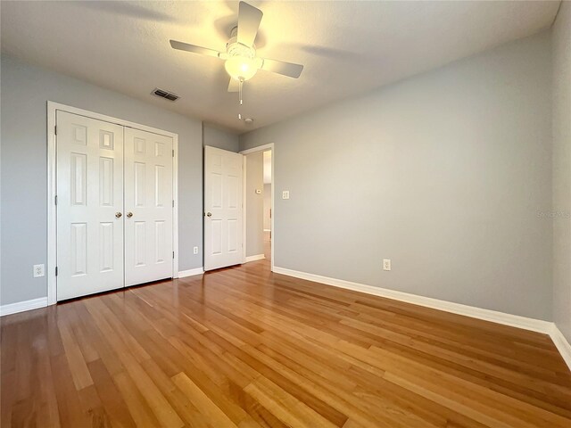 10915 Piping Rock Cir, Orlando, FL 32817 - unfurnished bedroom featuring visible vents, baseboards, and wood finished floors