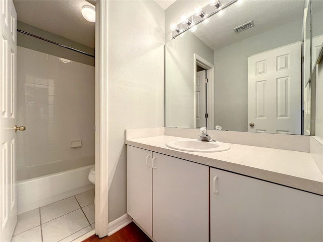 10915 Piping Rock Cir, Orlando, FL 32817 - full bath with vanity, visible vents,  shower combination, toilet, and tile patterned floors