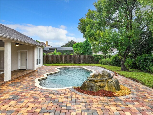 10915 Piping Rock Cir, Orlando, FL 32817 - view of pool with a patio, ceiling fan, a fenced in pool, and fence