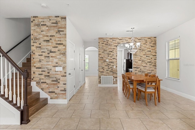 10866 Sunset Ridge Ln, Orlando, FL 32832 - dining space with a wealth of natural light, arched walkways, a notable chandelier, and visible vents