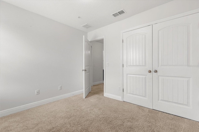 10866 Sunset Ridge Ln, Orlando, FL 32832 - unfurnished bedroom featuring a closet, light colored carpet, baseboards, and visible vents