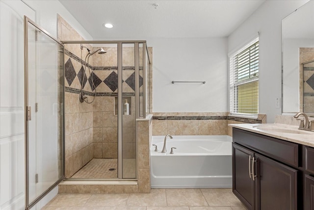 10866 Sunset Ridge Ln, Orlando, FL 32832 - full bathroom with a stall shower, a garden tub, vanity, and tile patterned flooring