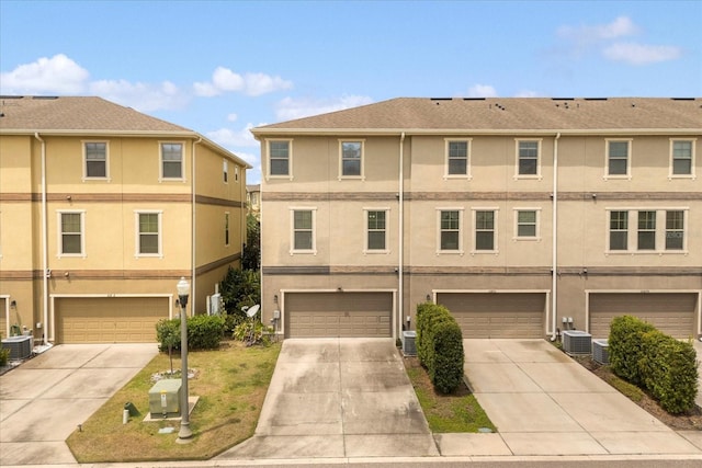 10866 Sunset Ridge Ln, Orlando, FL 32832 - multi unit property featuring cooling unit, a garage, stucco siding, and driveway