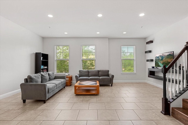 10866 Sunset Ridge Ln, Orlando, FL 32832 - living room with a healthy amount of sunlight, baseboards, and stairway