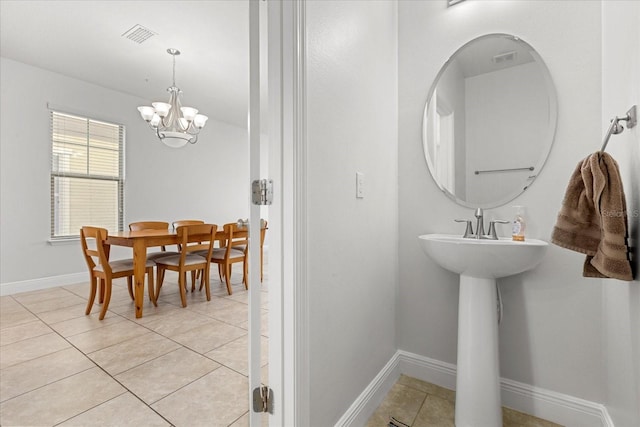 10866 Sunset Ridge Ln, Orlando, FL 32832 - bathroom with a chandelier, baseboards, tile patterned flooring, and visible vents