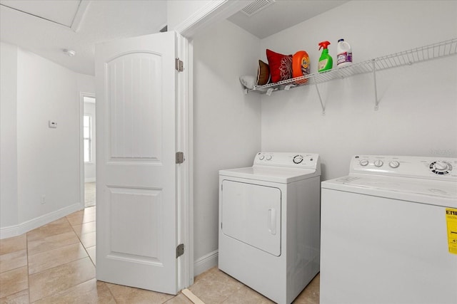 10866 Sunset Ridge Ln, Orlando, FL 32832 - laundry area with laundry area, visible vents, light tile patterned flooring, washer and dryer, and baseboards