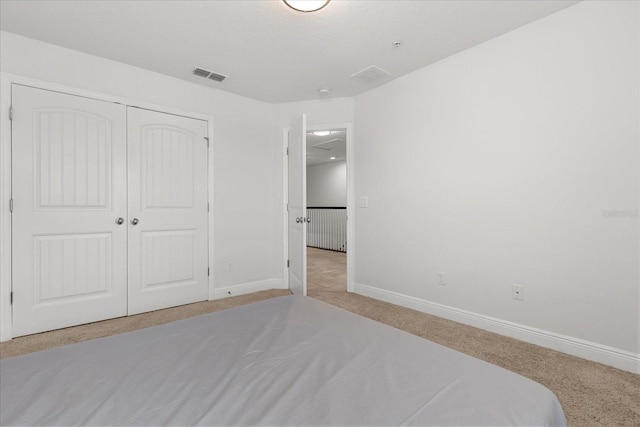 10866 Sunset Ridge Ln, Orlando, FL 32832 - unfurnished bedroom featuring visible vents, baseboards, a closet, and light colored carpet