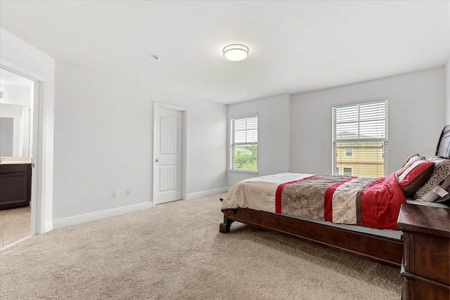 10866 Sunset Ridge Ln, Orlando, FL 32832 - bedroom featuring carpet flooring, baseboards, and ensuite bathroom