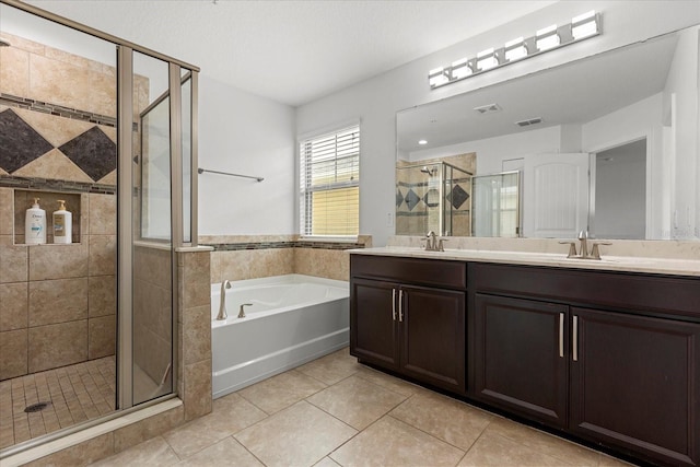 10866 Sunset Ridge Ln, Orlando, FL 32832 - bathroom featuring a garden tub, a shower stall, tile patterned flooring, visible vents, and a sink