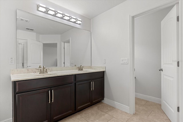 10866 Sunset Ridge Ln, Orlando, FL 32832 - full bathroom with tile patterned floors, double vanity, baseboards, and a sink