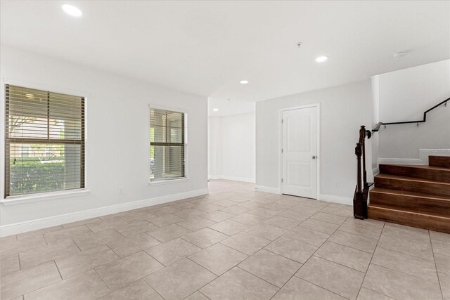 10866 Sunset Ridge Ln, Orlando, FL 32832 - empty room featuring baseboards, recessed lighting, light tile patterned flooring, and stairs