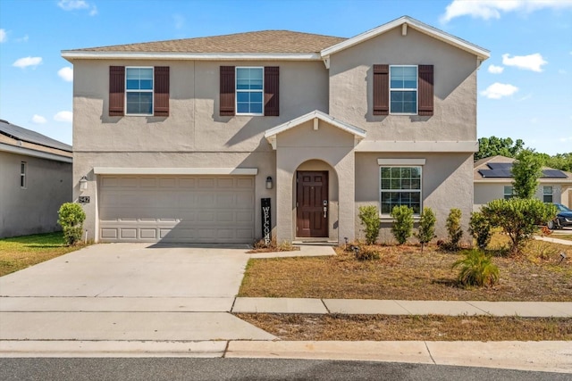 542 Patton Loop, Bartow, FL 33830 - traditional-style house with stucco siding, an attached garage, and driveway