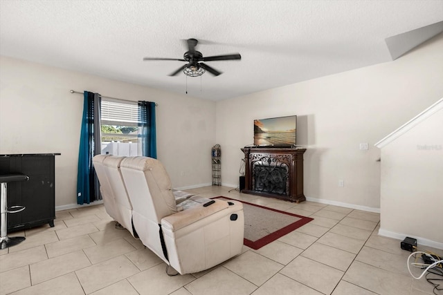 542 Patton Loop, Bartow, FL 33830 - living area with light tile patterned floors, ceiling fan, a fireplace, and a textured ceiling