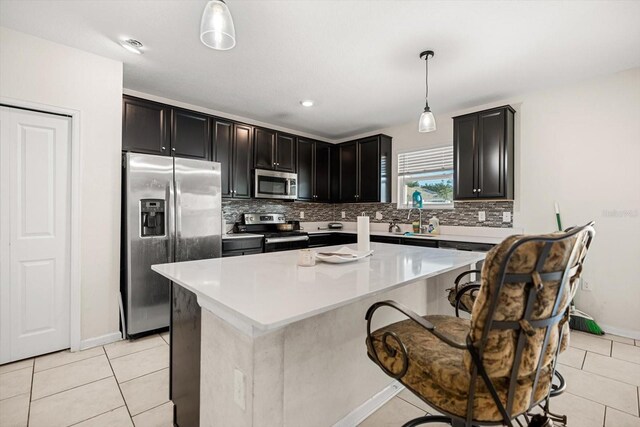 542 Patton Loop, Bartow, FL 33830 - kitchen with stainless steel appliances, backsplash, and light tile patterned flooring