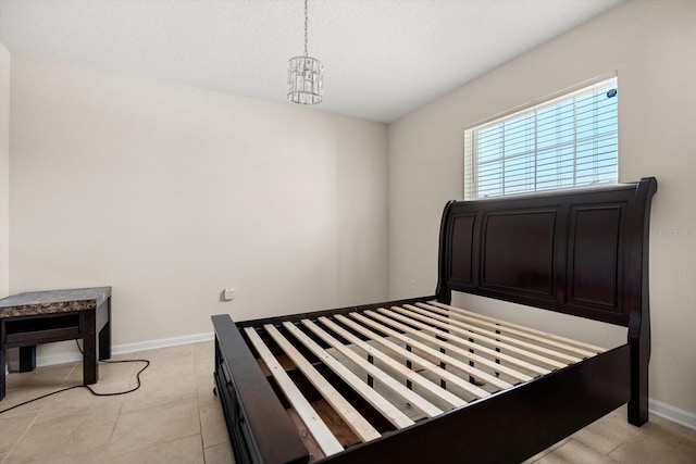 542 Patton Loop, Bartow, FL 33830 - bedroom featuring baseboards, a chandelier, and light tile patterned floors