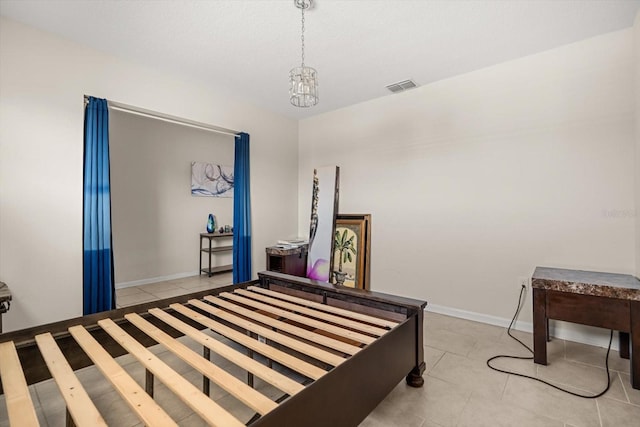 542 Patton Loop, Bartow, FL 33830 - bedroom with light tile patterned floors, a chandelier, and baseboards