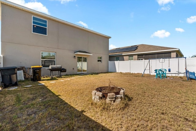 542 Patton Loop, Bartow, FL 33830 - rear view of property featuring an outdoor fire pit