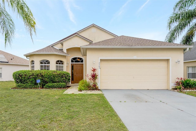 7762 Newlan Dr, Orlando, FL 32818 - ranch-style home with an attached garage, concrete driveway, stucco siding, and a front lawn