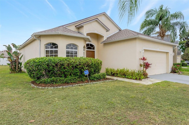 7762 Newlan Dr, Orlando, FL 32818 - ranch-style home with driveway, stucco siding, a front lawn, and a garage