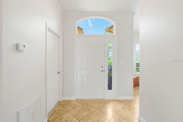7762 Newlan Dr, Orlando, FL 32818 - entrance foyer with light tile patterned floors, visible vents, baseboards, and crown molding