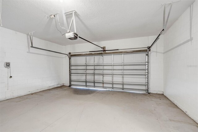 7762 Newlan Dr, Orlando, FL 32818 - garage featuring concrete block wall and a garage door opener