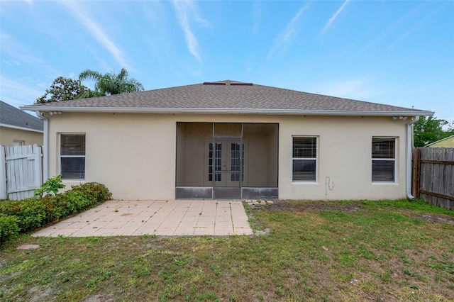 7762 Newlan Dr, Orlando, FL 32818 - back of house featuring fence, stucco siding, french doors, and a lawn
