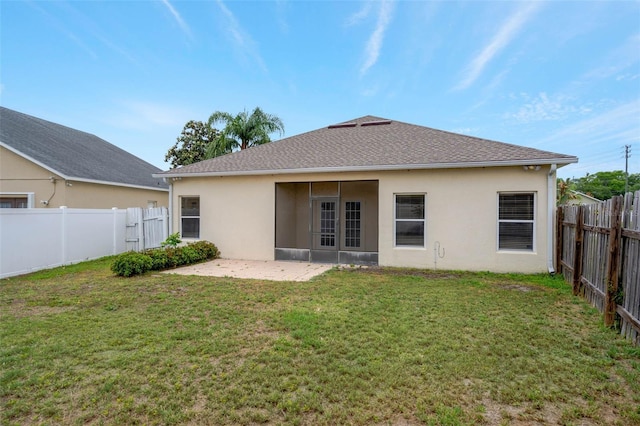 7762 Newlan Dr, Orlando, FL 32818 - rear view of house with a patio, roof with shingles, stucco siding, a fenced backyard, and a yard