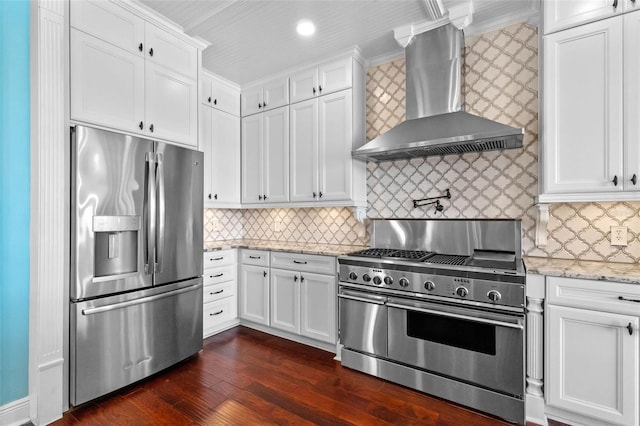 3583 Valleyview Dr, Kissimmee, FL 34746 - kitchen with appliances with stainless steel finishes, dark wood-type flooring, white cabinets, and wall chimney exhaust hood