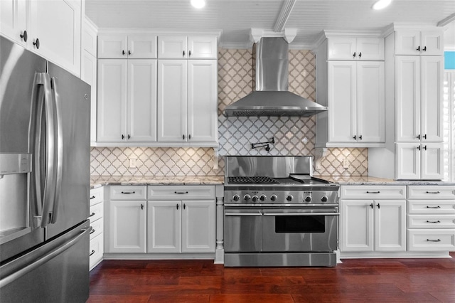 3583 Valleyview Dr, Kissimmee, FL 34746 - kitchen featuring light stone countertops, appliances with stainless steel finishes, white cabinets, wall chimney exhaust hood, and crown molding