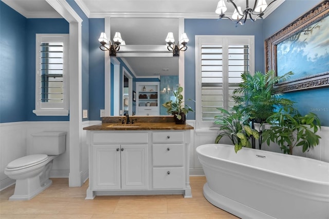 3583 Valleyview Dr, Kissimmee, FL 34746 - bathroom featuring vanity, a notable chandelier, toilet, ornamental molding, and a soaking tub