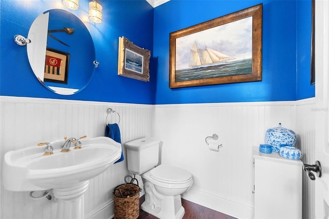 3583 Valleyview Dr, Kissimmee, FL 34746 - bathroom with wood finished floors, a wainscoted wall, and toilet