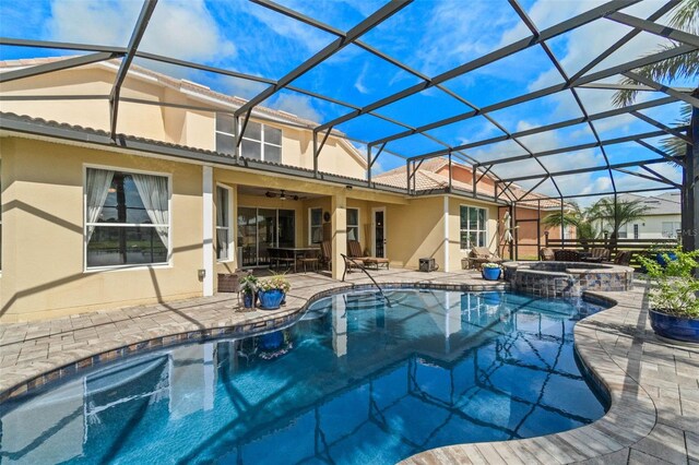 3583 Valleyview Dr, Kissimmee, FL 34746 - back of property with a patio, a pool with connected hot tub, ceiling fan, a lanai, and stucco siding