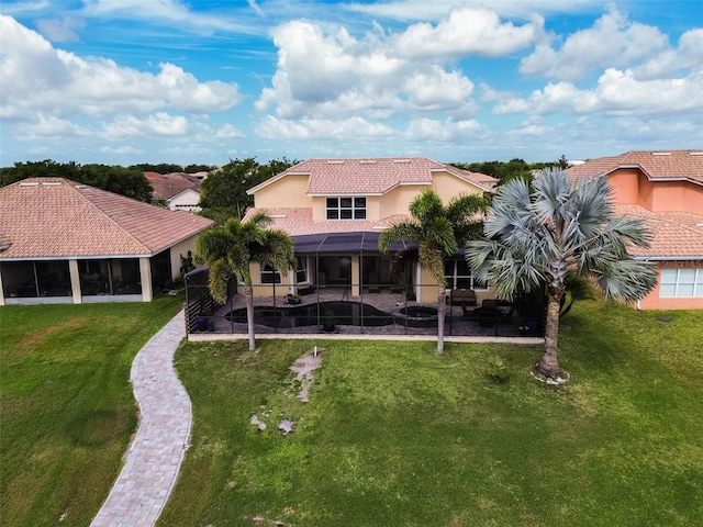 3583 Valleyview Dr, Kissimmee, FL 34746 - rear view of house featuring a patio, a lawn, a tiled roof, a lanai, and stucco siding